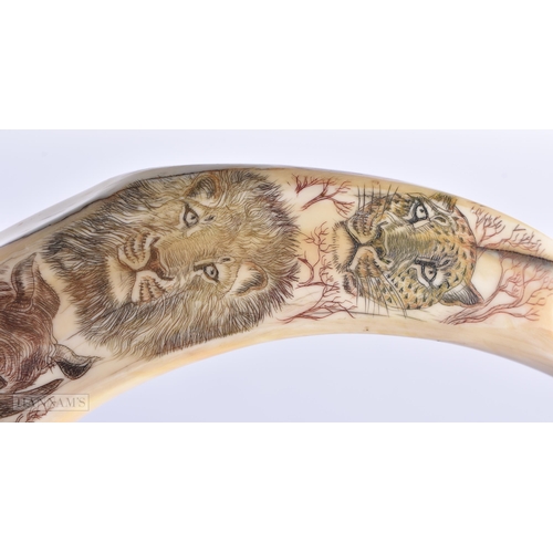 10 - AN EARLY 20TH CENTURY CARVED SCRIMSHAW WILD AFRICAN ANIMAL WALKING CANE. 90 cm long.