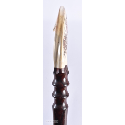 10 - AN EARLY 20TH CENTURY CARVED SCRIMSHAW WILD AFRICAN ANIMAL WALKING CANE. 90 cm long.