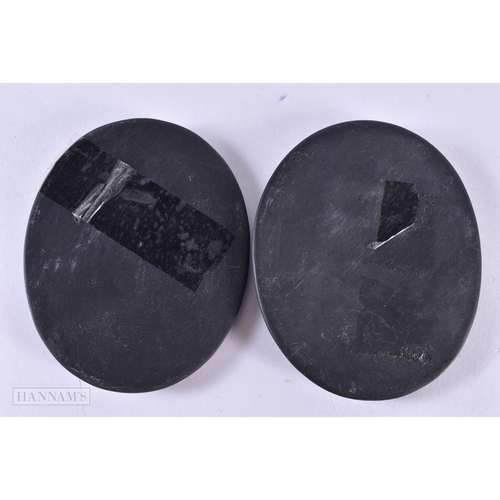 115 - A PAIR OF ANTIQUE BLACK BASALT PORTRAIT MEDALLIONS. 78.9 grams. 8.5 cm x 6.5 cm.