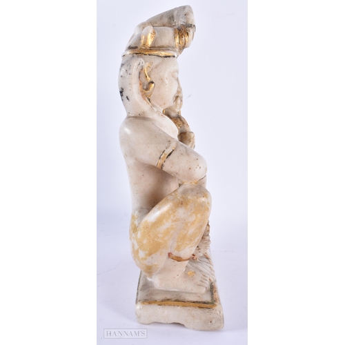 130 - AN 18TH/19TH CENTURY INDIAN RAJASTHAN LACQUERED MARBLE FIGURE OF A DEITY modelled with an attendant.... 