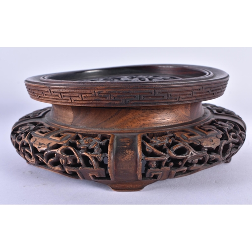 153 - A FINE 19TH CENTURY CHINESE CARVED HARDWOOD STAND Qing, decorated with extensive foliage and vines. ... 