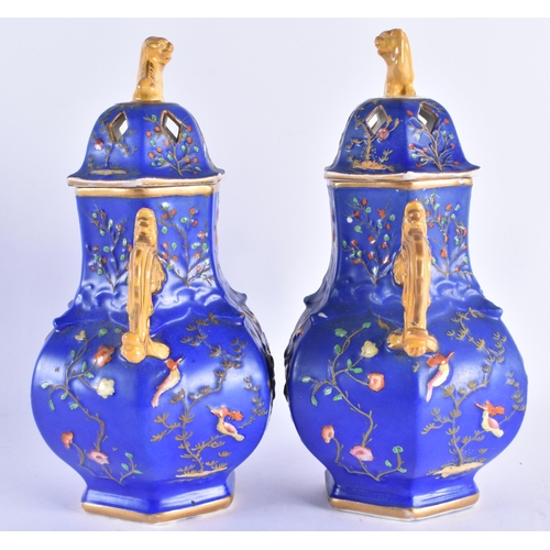 187 - AN UNUSUAL PAIR OF MID 19TH CENTURY ENGLISH VASES AND COVERS decorated in relief with birds and foli... 