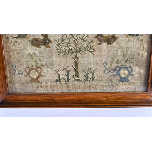 195 - A FRAMED ANTIQUE EMBROIDERED SAMPLER decorated with rabbits , birds and a house. 48 cm x 30 cm.