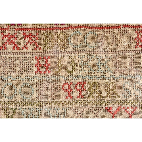 196 - A FRAMED ANTIQUE EMBROIDERED SAMPLER decorated with letters from the alphabet. 48 cm x 32 cm.