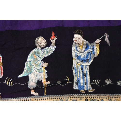 199 - A LARGE 19TH CENTURY CHINESE SILK EMBROIDERED PURPLE PANEL Qing, decorated with immortals. 155 cm x ... 