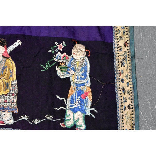 199 - A LARGE 19TH CENTURY CHINESE SILK EMBROIDERED PURPLE PANEL Qing, decorated with immortals. 155 cm x ... 