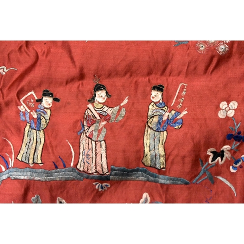 200 - A LARGE 19TH CENTURY CHINESE SILK EMBROIDERED RED PANEL Qing, decorated with figures in a landscape.... 