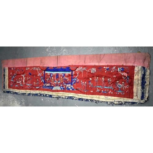 200 - A LARGE 19TH CENTURY CHINESE SILK EMBROIDERED RED PANEL Qing, decorated with figures in a landscape.... 