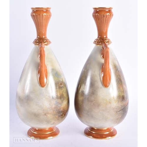 22 - A PAIR OF ROYAL WORCESTER TWIN HANDLED PORCELAIN VASES by James Stinton, painted with game birds. 21... 