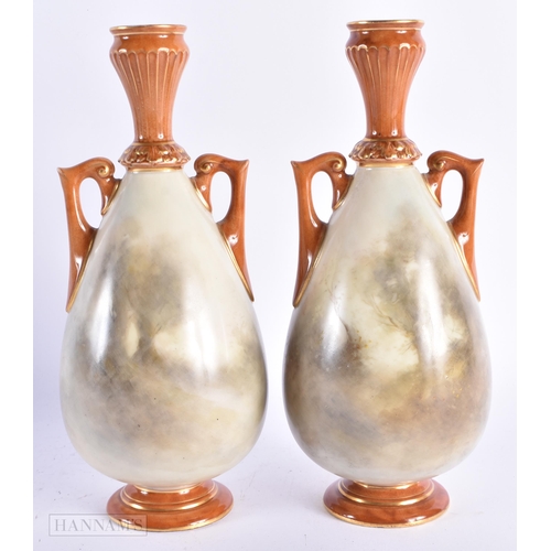 22 - A PAIR OF ROYAL WORCESTER TWIN HANDLED PORCELAIN VASES by James Stinton, painted with game birds. 21... 