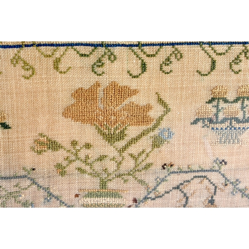 229 - A LARGE 19TH CENTURY FRAMED AND EMBROIDERED SAMPLER by Emma Twitchin aged 9 years. 58 cm square.