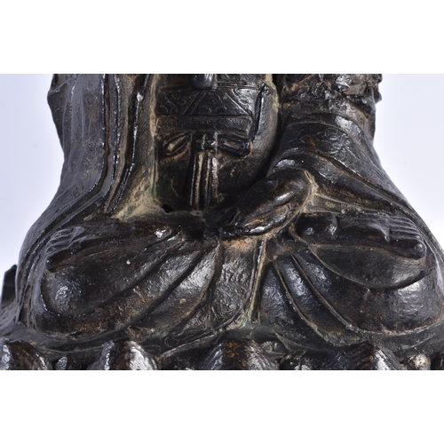 231 - A 17TH CENTURY CHINESE BRONZE FIGURE OF A BUDDHA Ming, modelled with one hand raised upon a lotus ca... 