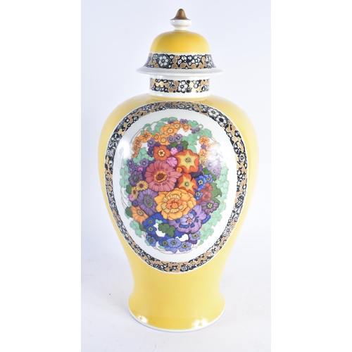 238 - AN UNUSUAL LARGE GERMAN KPM BERLIN PORCELAIN VASE AND COVER painted with bold flowers upon a rich ye... 