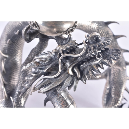 244 - A FINE AND RARE 19TH CENTURY JAPANESE MEIJI PERIOD SILVER DRAGON VASE decorated in relief with drago... 