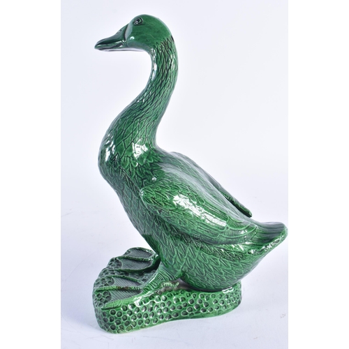 246 - A LARGE 19TH CENTURY CHINESE GREEN MONOCHROME PORCELAIN DUCK Kangxi style. 25.5 cm high.