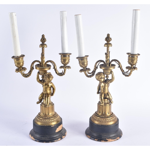 258 - A PAIR OF 19TH CENTURY FRENCH GILT BRONZE CANDLESTICKS modelled with nude figures. 38 cm high.