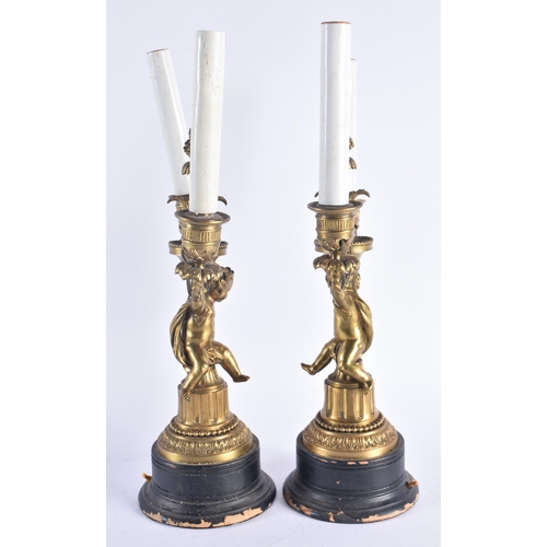 258 - A PAIR OF 19TH CENTURY FRENCH GILT BRONZE CANDLESTICKS modelled with nude figures. 38 cm high.