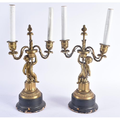 258 - A PAIR OF 19TH CENTURY FRENCH GILT BRONZE CANDLESTICKS modelled with nude figures. 38 cm high.