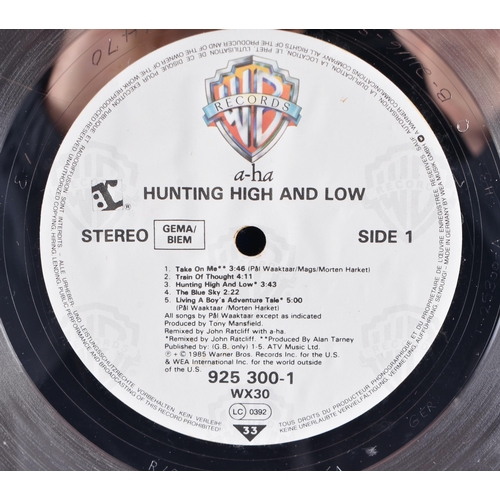 273 - AH-HA Hunting high and low German platinum disc presented to Andy Wickham to commemorate 500,000 sal... 