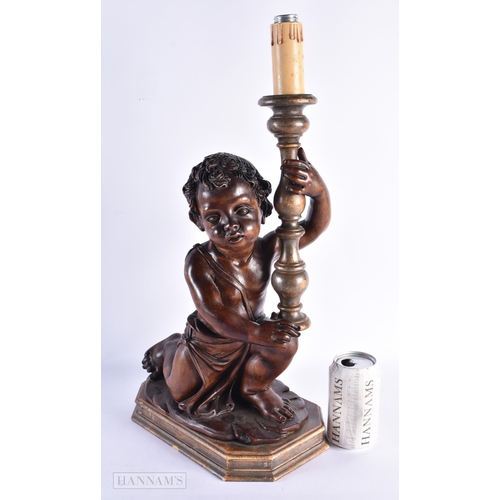 33 - A LARGE 18TH/19TH CENTURY ITALIAN CARVED WOOD LAMP modelled holding aloft a candlestick. 52 cm x 24 ... 