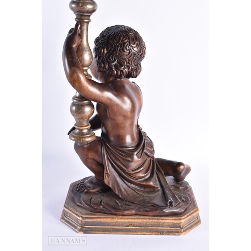 33 - A LARGE 18TH/19TH CENTURY ITALIAN CARVED WOOD LAMP modelled holding aloft a candlestick. 52 cm x 24 ... 