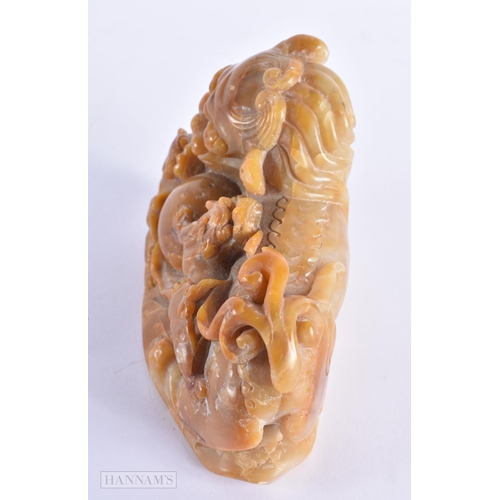 37 - A 19TH CENTURY CHINESE CARVED SOAPSTONE FIGURE OF A BUDDHIST LION possibly Tianhuang. 15.5 cm x 11 c... 