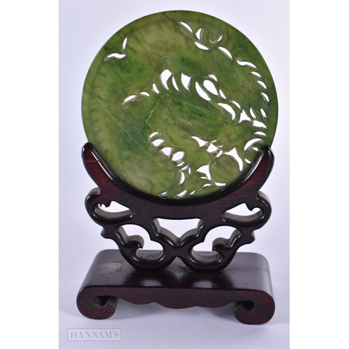 48 - A 19TH CENTURY CHINESE CARVED SPINACH JADE CIRCULAR PLAQUE Qing, decorated with a dragon. 14 cm x 9 ... 