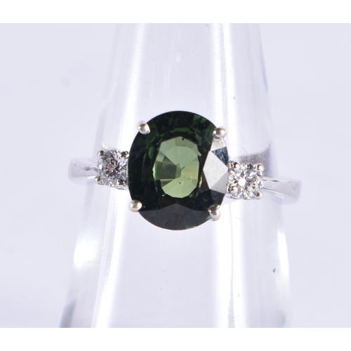 510 - AN 18CT GOLD DIAMOND AND GREEN SAPPHIRE RING. 4 grams.