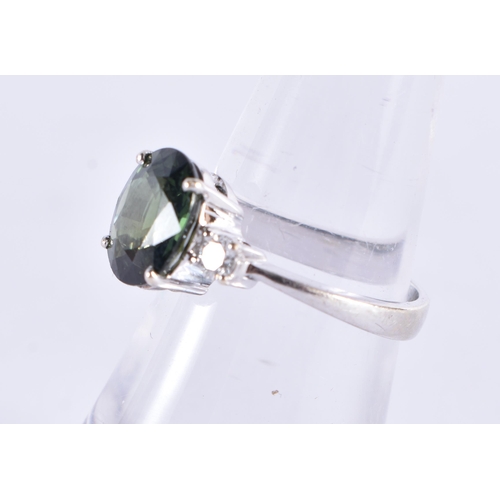 510 - AN 18CT GOLD DIAMOND AND GREEN SAPPHIRE RING. 4 grams.