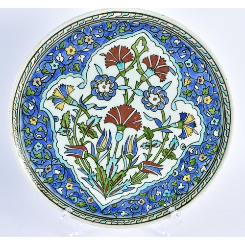 514 - AN IZNIK FAIENCE DISH together with a studio pottery censer. Largest 24 cm diameter. (2)