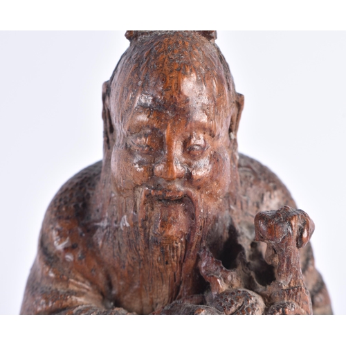 516 - A CHINESE QING DYNASTY CARVED BAMBOO FIGURE OF A SCHOLAR. 14 cm high.