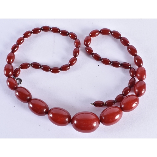 519 - Cherry Bakelite Beads w/ Internal Streaking. 71 grams. 72 cm long, largest bead 3 cm x 2 cm.