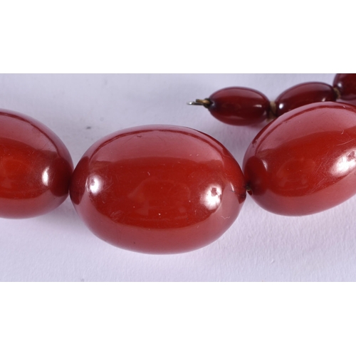 519 - Cherry Bakelite Beads w/ Internal Streaking. 71 grams. 72 cm long, largest bead 3 cm x 2 cm.