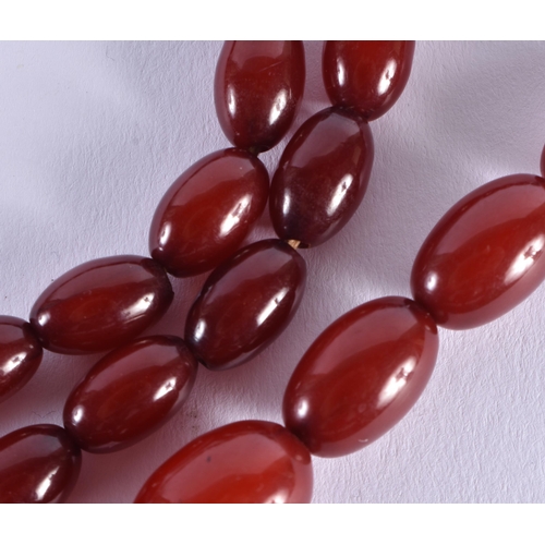 519 - Cherry Bakelite Beads w/ Internal Streaking. 71 grams. 72 cm long, largest bead 3 cm x 2 cm.