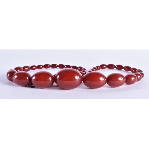 519 - Cherry Bakelite Beads w/ Internal Streaking. 71 grams. 72 cm long, largest bead 3 cm x 2 cm.