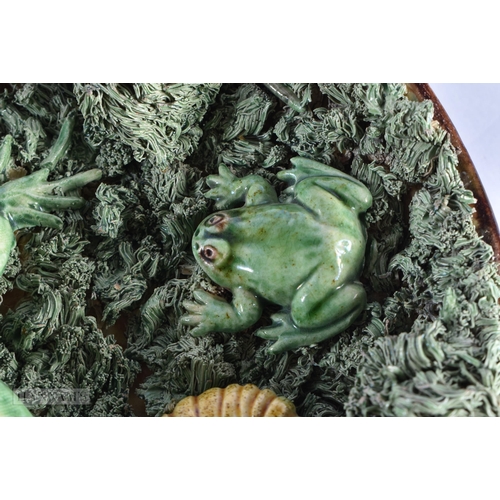 57 - AN ANTIQUE PORTUGUESE MAJOLICA POTTERY LIZARD DISH encrusted with shells and toads. 19 cm wide.