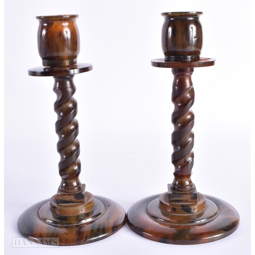 65 - A PAIR OF ART DECO FAUX TORTOISESHELL BAKELITE CANDLESTICKS. 18 cm high.