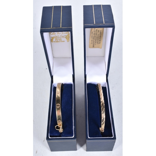 659 - Two 9 Carat Gold Bangles in Fitted cases. Stamped 375. Internal 6.5cm x 5cm, total weight 30.8g incl... 