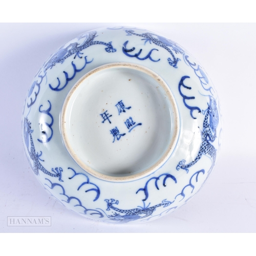 69 - A 19TH CENTURY CHINESE BLUE AND WHITE PORCELAIN DRAGON BOWL bearing Kangxi marks to base. 20.5 cm di... 