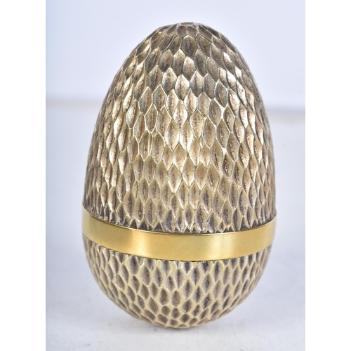 704 - A limited-edition silver gilt surprise egg by Stuart Devlin, London, c.1976, opening to reveal a Rob... 