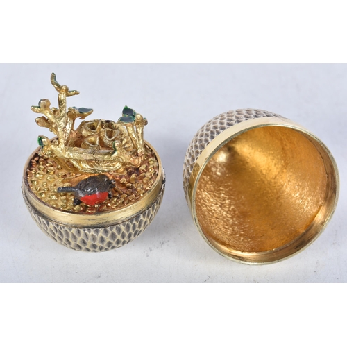 704 - A limited-edition silver gilt surprise egg by Stuart Devlin, London, c.1976, opening to reveal a Rob... 