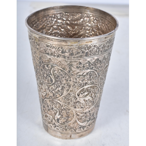 725 - A Middle Eastern Silver Drinking Cup with Embossed Foliate Decoration.  9.4cm x 6.7cm, weight 61.9g