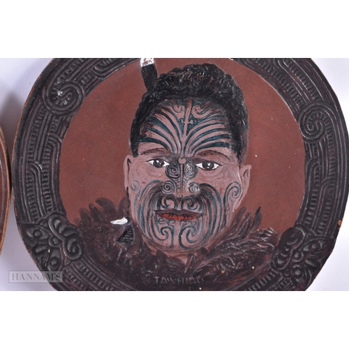 79 - A PAIR OF NEW ZEALAND MAORI PAINTED LEATHER TRIBAL PANELS. 20 cm wide.