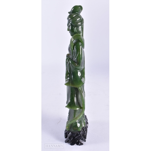 84 - A LATE 19TH CENTURY CHINESE CARVED SPINACH JADE FIGURE OF AN IMMORTAL Late Qing. 19 cm high.