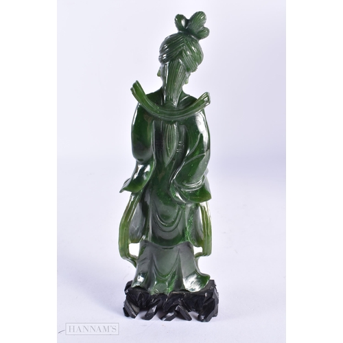 84 - A LATE 19TH CENTURY CHINESE CARVED SPINACH JADE FIGURE OF AN IMMORTAL Late Qing. 19 cm high.