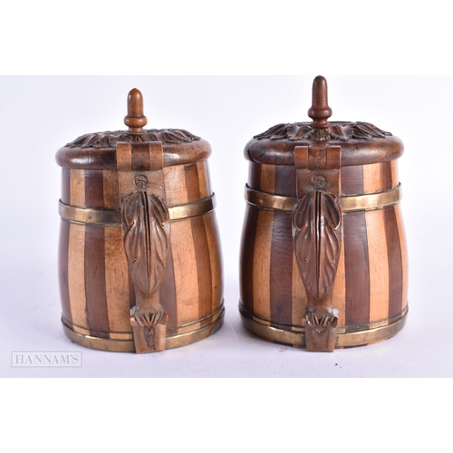 86 - A CHARMING PAIR OF ANTIQUE TREEN TANKARDS carved with leaves. 14 cm x 7 cm.