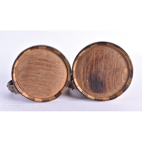 86 - A CHARMING PAIR OF ANTIQUE TREEN TANKARDS carved with leaves. 14 cm x 7 cm.