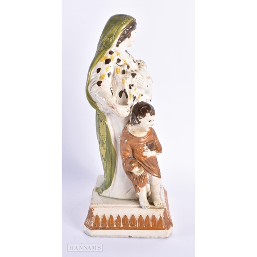 93 - A LARGE LATE 18TH/19TH CENTURY CREAMWARE FIGURE OF A FEMALE modelled beside children. 25 cm high.