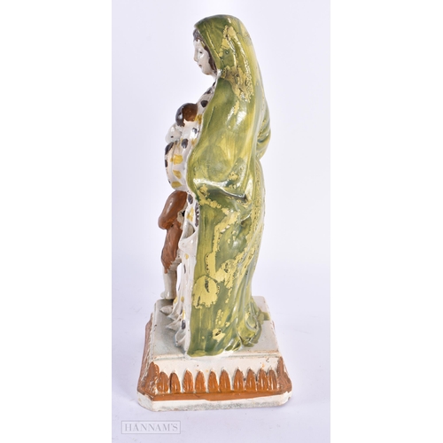 93 - A LARGE LATE 18TH/19TH CENTURY CREAMWARE FIGURE OF A FEMALE modelled beside children. 25 cm high.