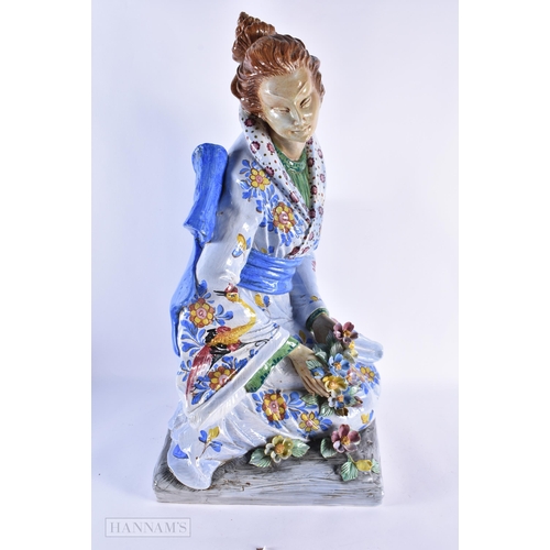 98 - A VERY LARGE PAIR OF ITALIAN CERAMIC POTTERY FIGURES OF A MALE AND FEMALE modelled in robes embellis... 